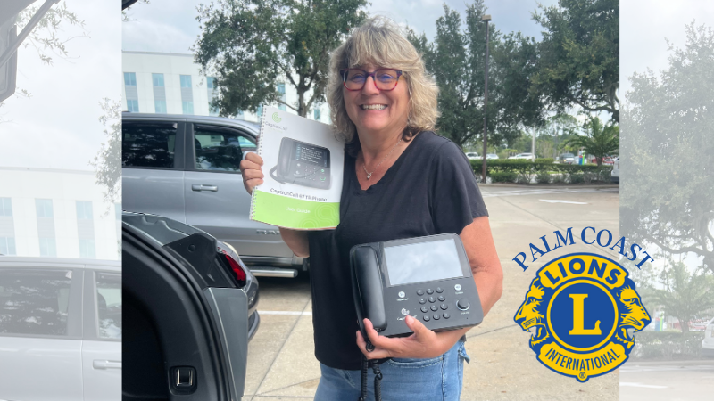 Cathy McDermott Holding CaptionCall Phone for donation.