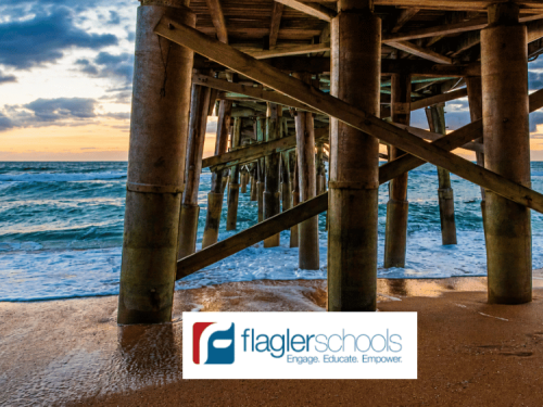 View from beneath the Flagler Beach Pier showing ocean waves rolling onto the shoreline at sunset, representing marine ecosystems, coastal environments, and ocean conservation efforts connected to Flagler Schools being named a Guy Harvey Conservation District in Flagler County, Florida.
